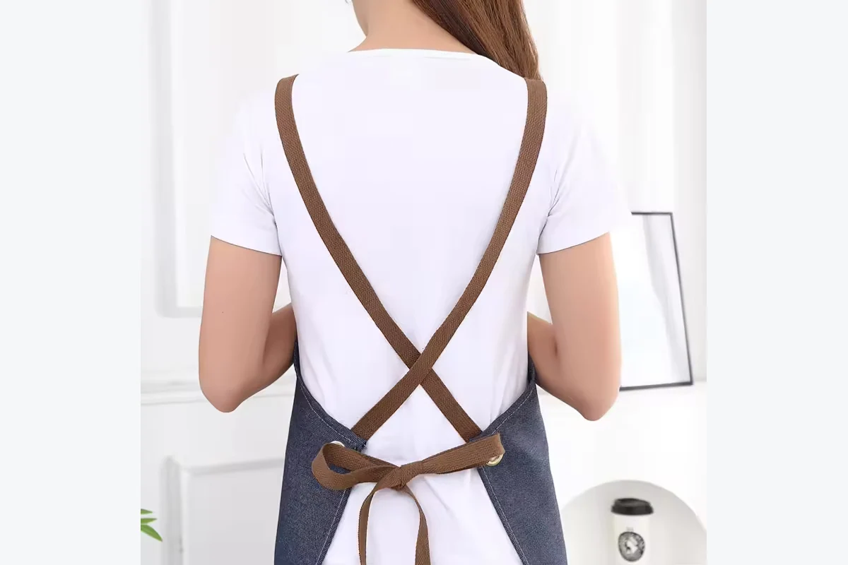 Apron shoulder straps crossing at the back.