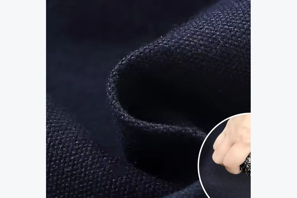 Folded dark woven apron material.
