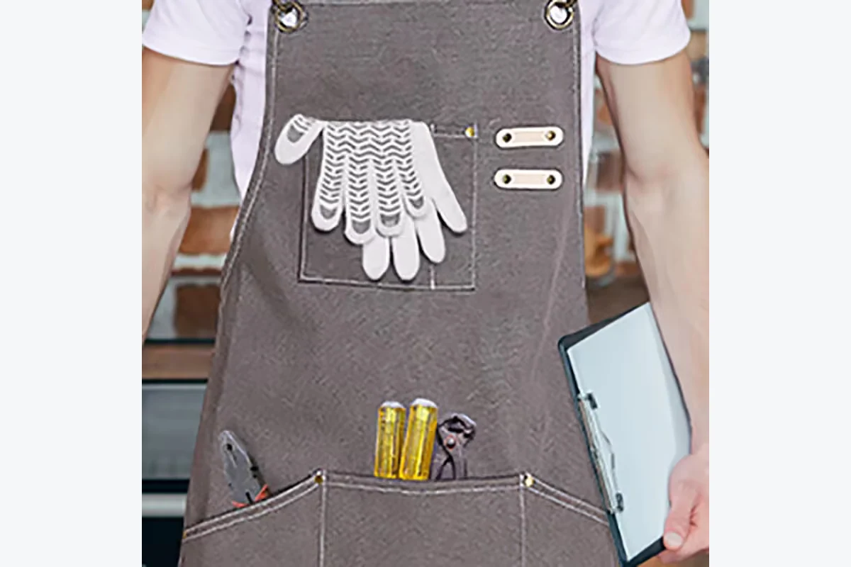 Gray apron with gloves, screwdrivers, and a wrench in its front pockets.