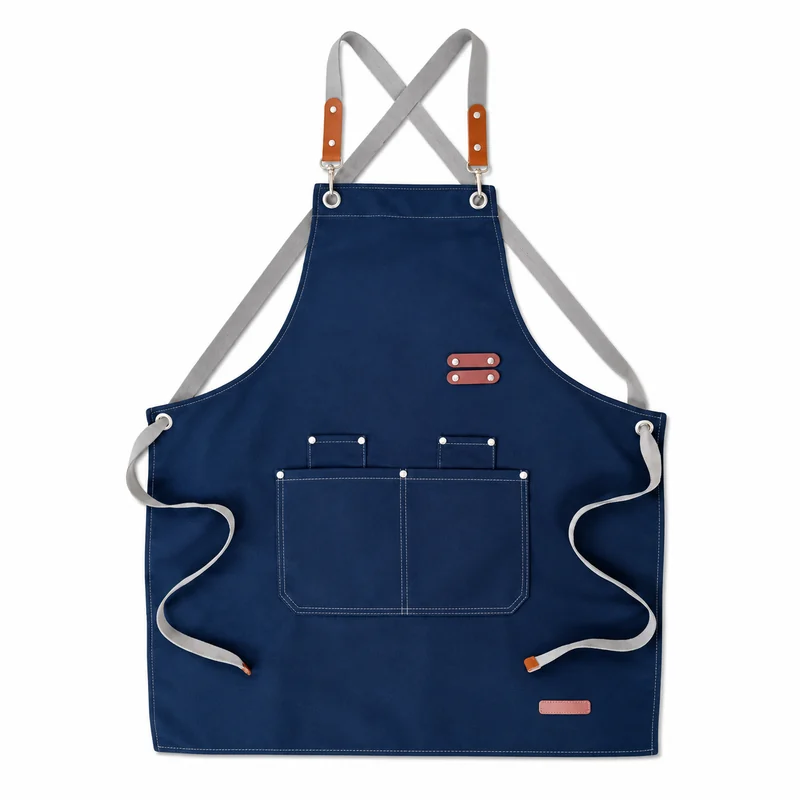 Navy apron with crossed straps and front storage pockets.