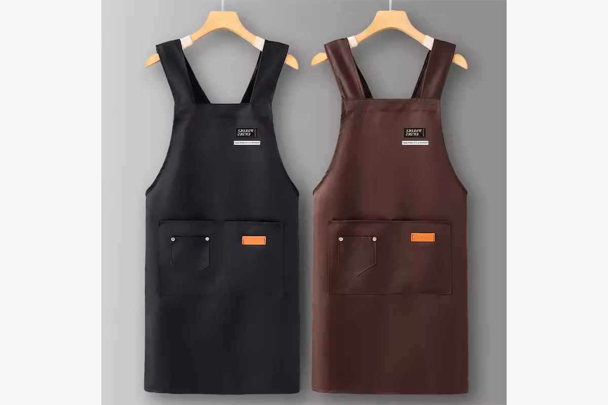 Black and brown aprons hanging side by side.
