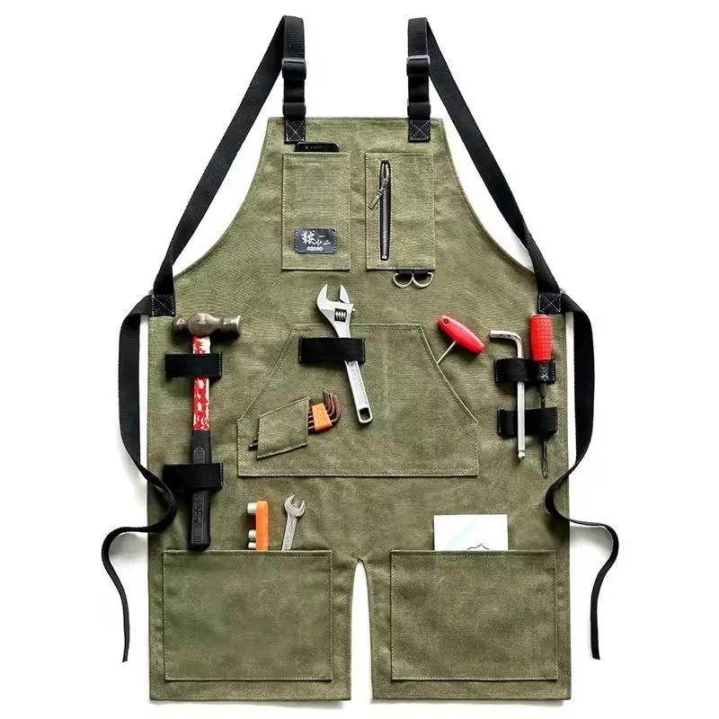 Olive work apron holding hand tools in its front pockets.