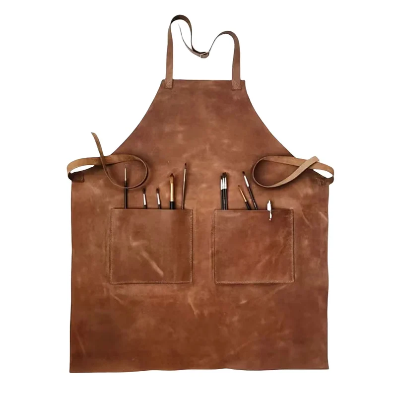 Brown apron with two front pockets holding brushes.