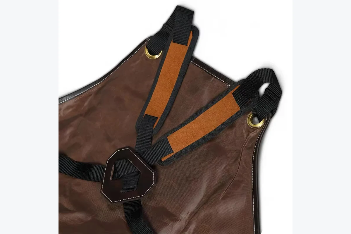 Padded apron straps with metal eyelets and a back strap guide.