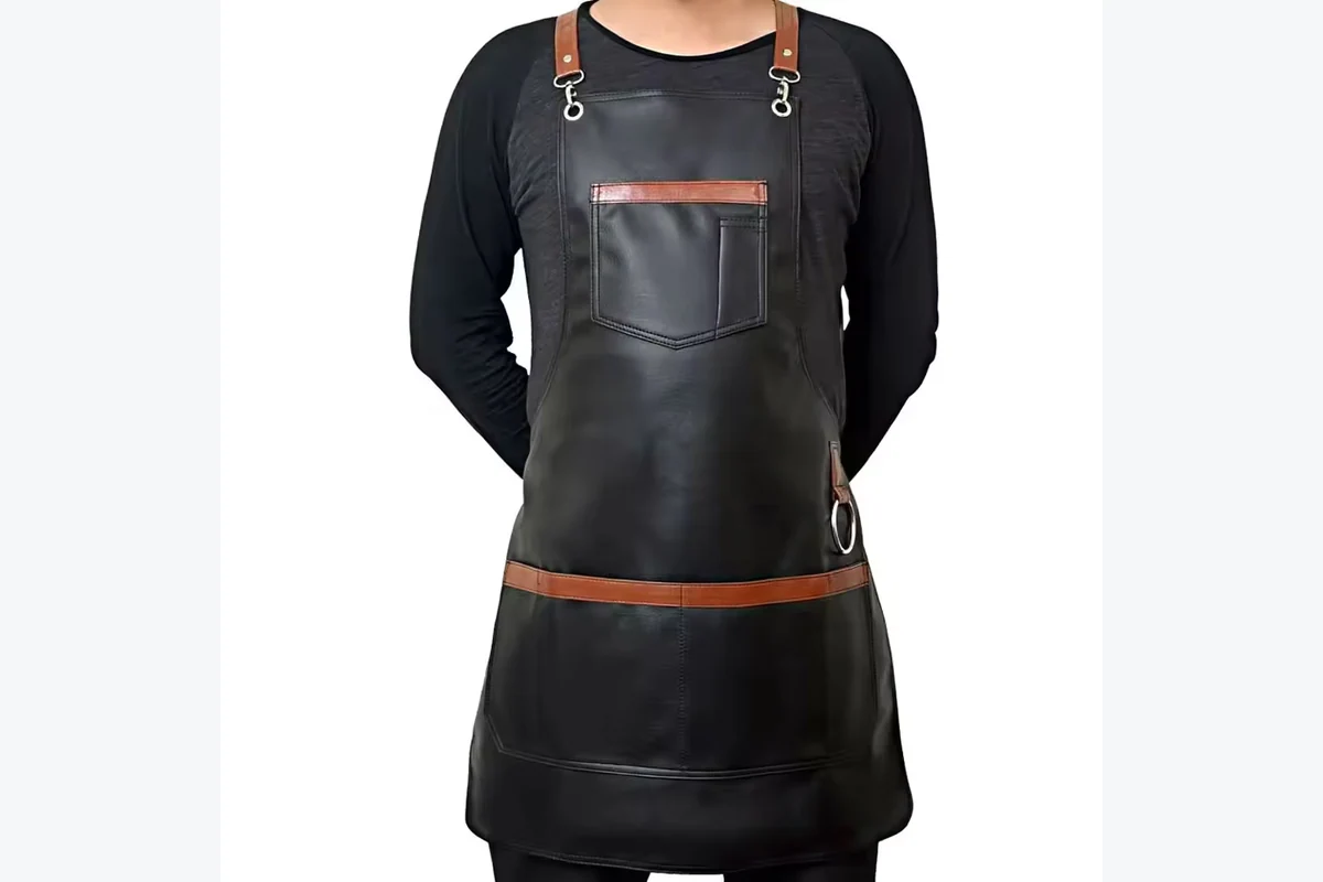 Black apron with a smooth surface and front pocket.