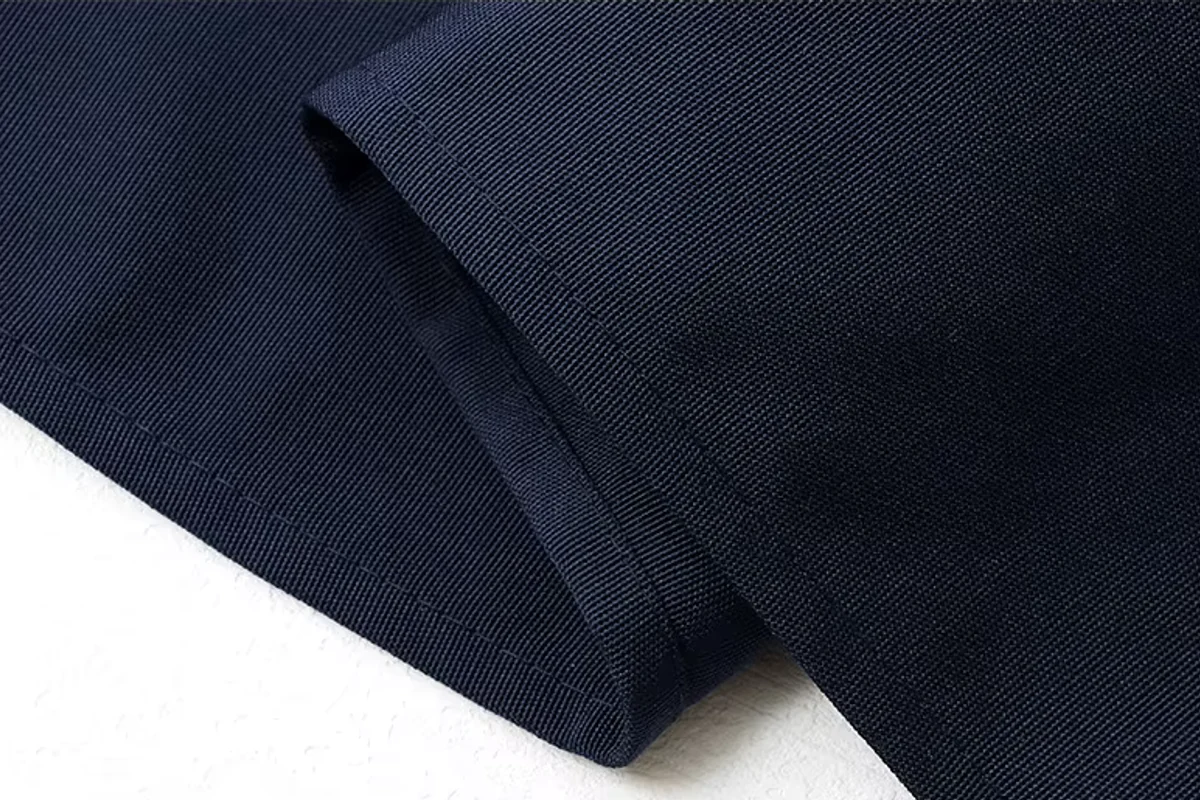 Close view of folded navy apron fabric.