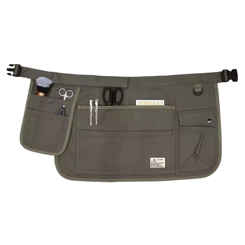 Olive waist apron with divided storage pockets and metal fasteners.