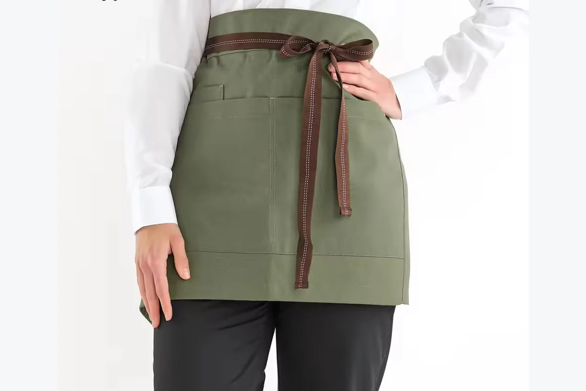 An olive waist apron tied around the waist.