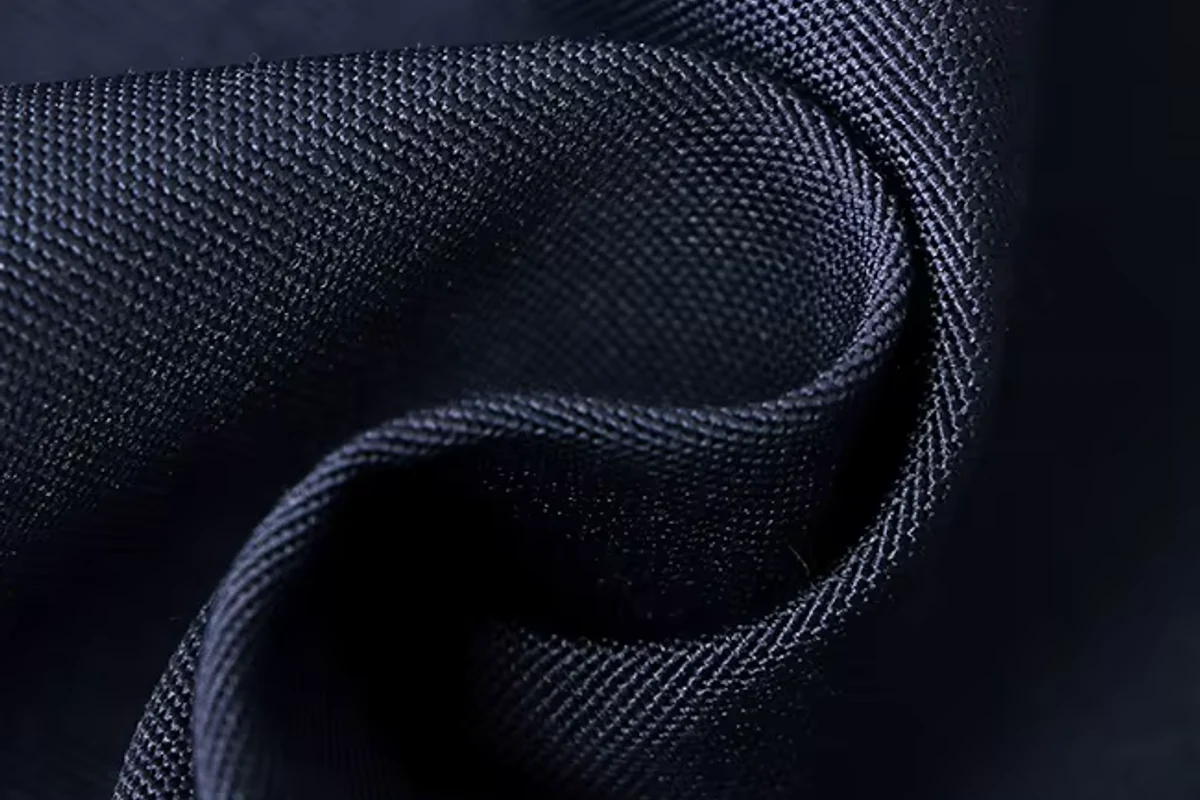 Folded navy material with a visible woven surface.