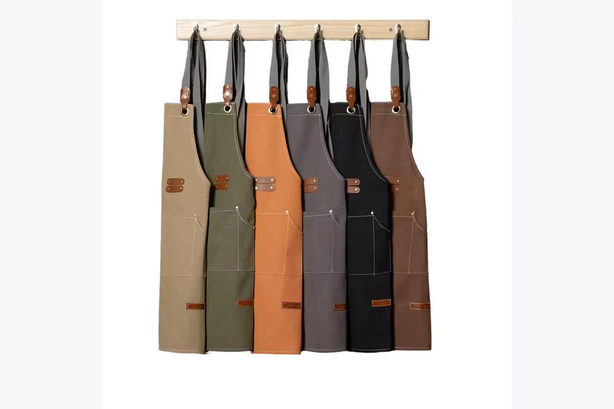 Tool aprons hanging in brown, green, orange, gray, and black.