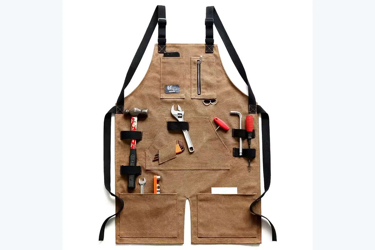 Brown apron with hand tools secured in front loops and pockets.