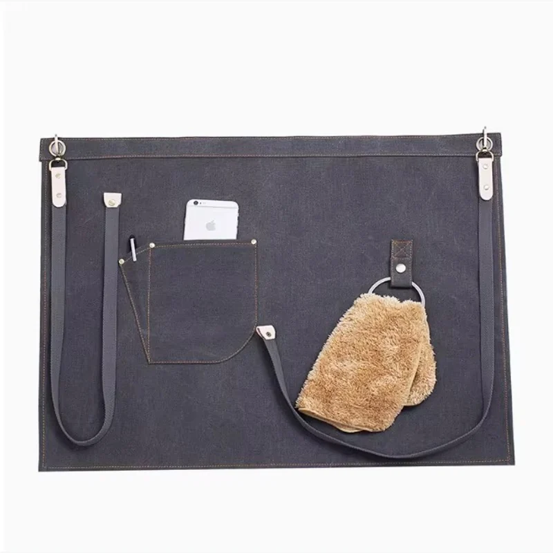 Dark waist apron with a front pocket, side clips, and tool loops.