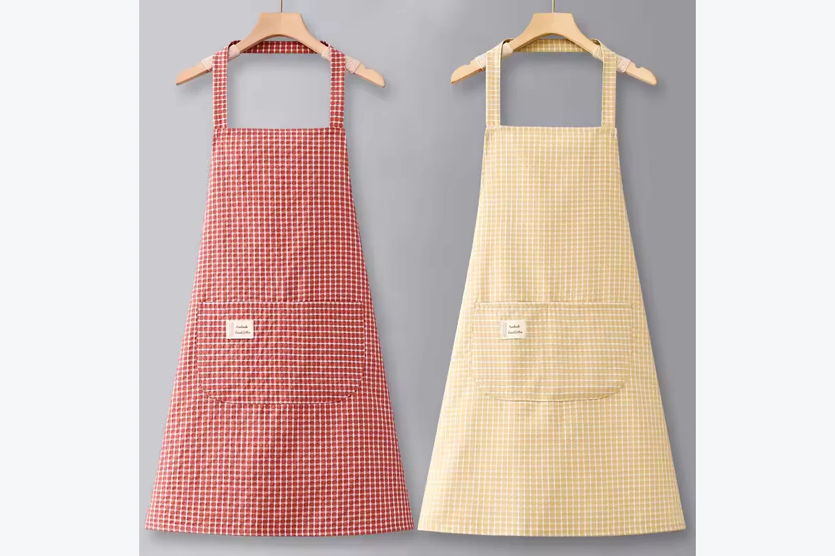 Red and yellow gingham aprons hanging side by side.