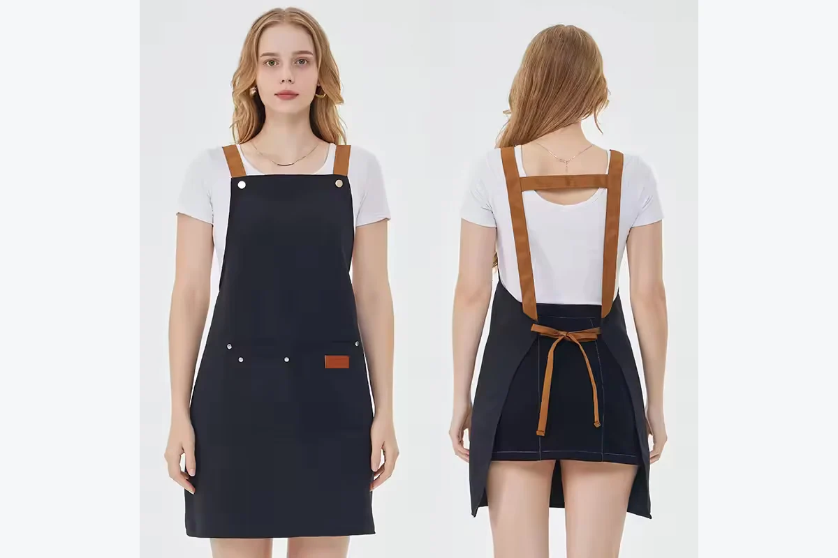 Front and back views of a navy apron with brown H-back straps.
